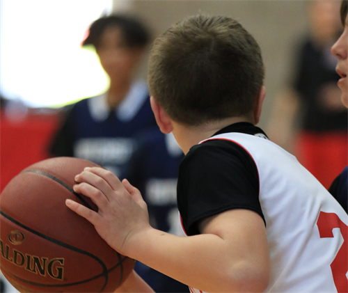 A student about to pass a basketball